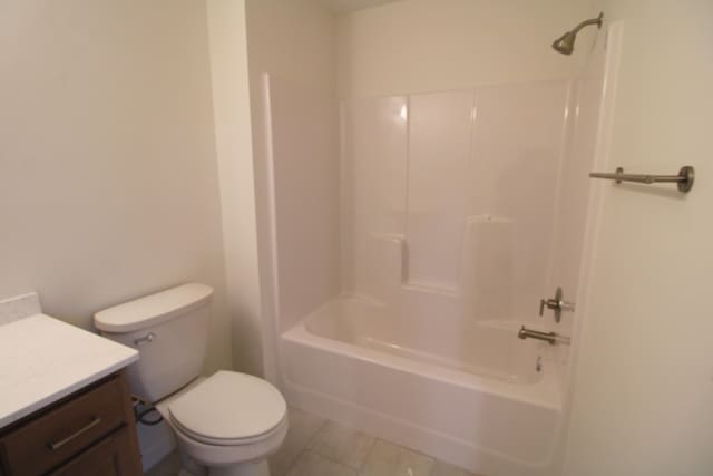 full bathroom featuring vanity, shower / washtub combination, toilet, and tile patterned floors