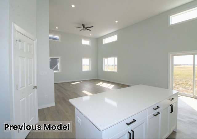 kitchen featuring a wealth of natural light, a kitchen island, and white cabinets