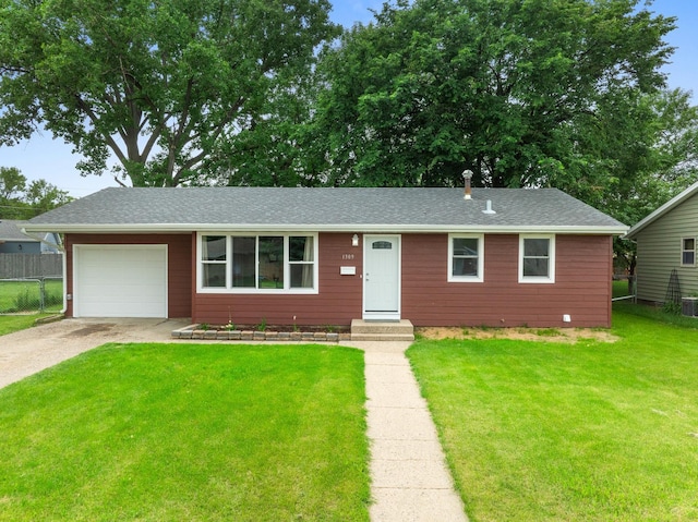 ranch-style home with a front yard and a garage