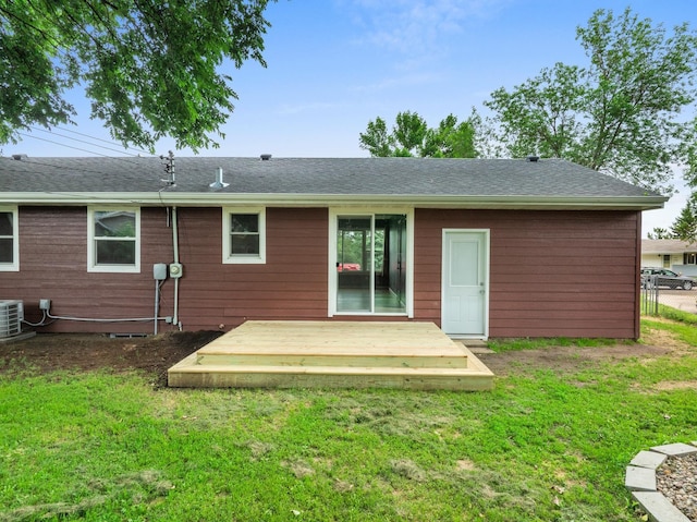 rear view of house featuring a yard and a deck