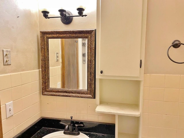 bathroom with tile walls and sink