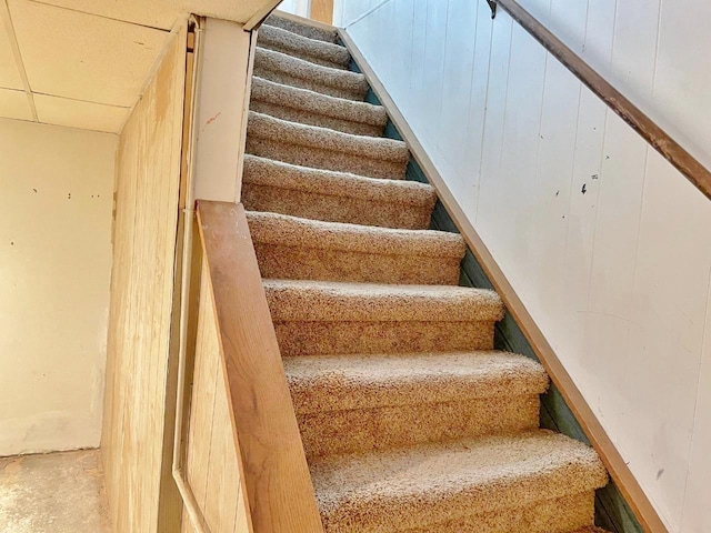 staircase featuring concrete flooring