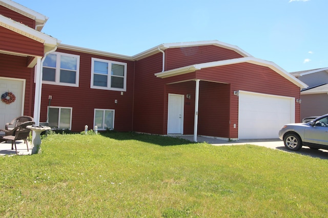 view of front of property with a front lawn and a garage