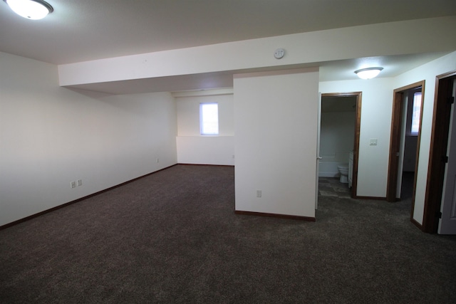 basement featuring dark carpet