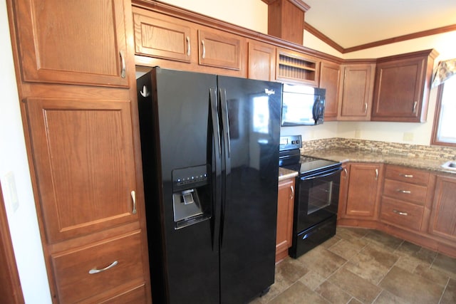 kitchen featuring light stone countertops, black appliances, lofted ceiling, and ornamental molding