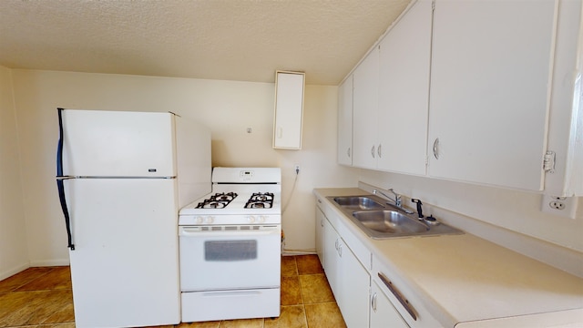 kitchen featuring light tile patterned flooring, white cabinetry, white appliances, a textured ceiling, and sink