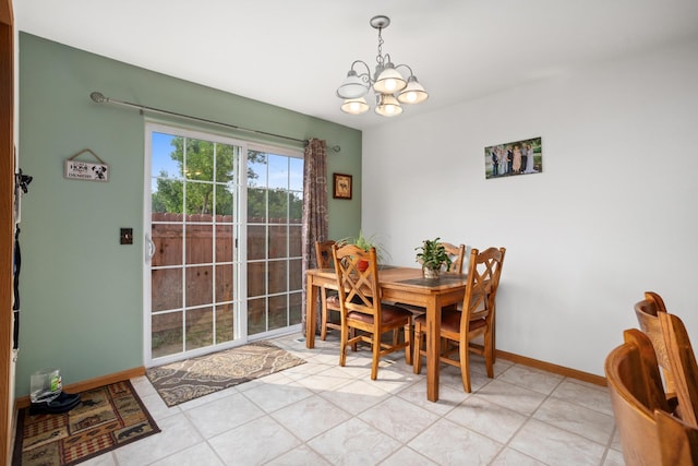 dining area featuring a notable chandelier and light tile patterned floors