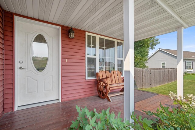 view of exterior entry featuring covered porch