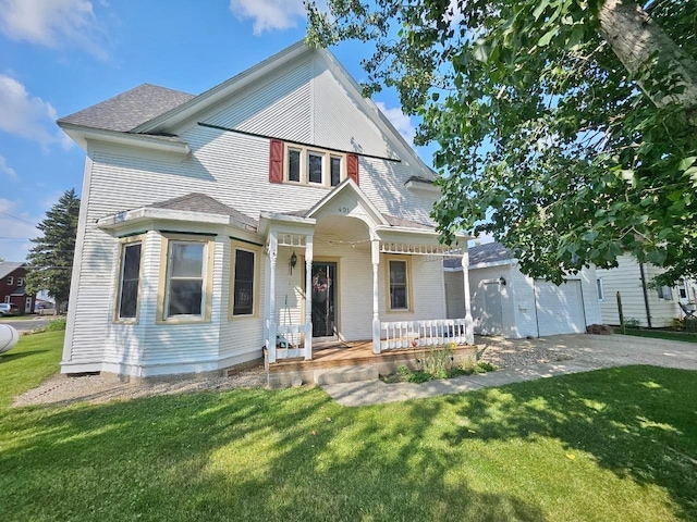 victorian-style house with a garage and a front lawn