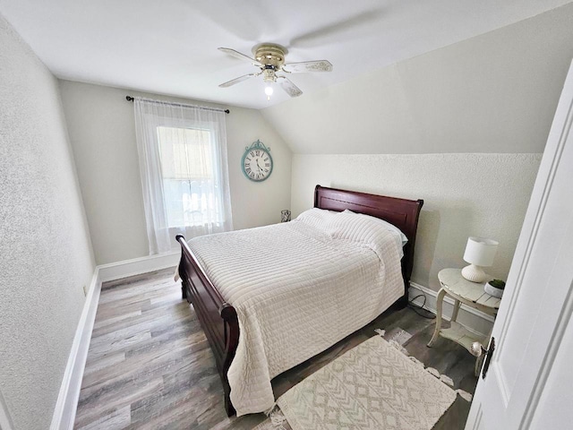 401 5th St, Rugby, ND 58368 - bedroom featuring baseboards, a textured wall, wood finished floors, and vaulted ceiling