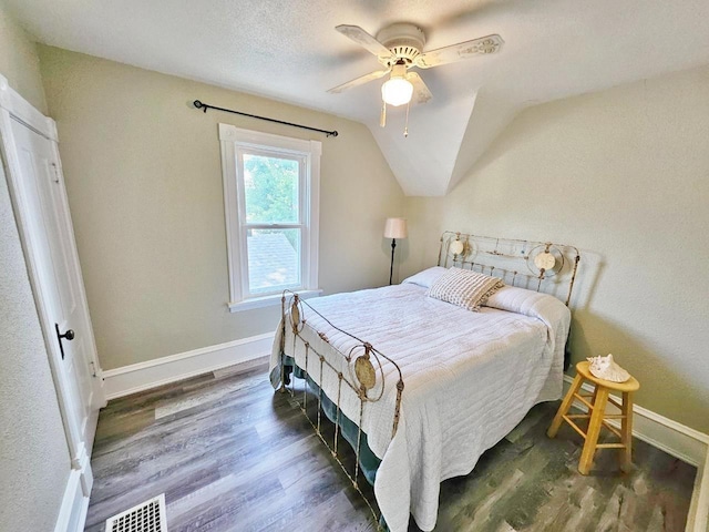 401 5th St, Rugby, ND 58368 - bedroom featuring visible vents, baseboards, lofted ceiling, and wood finished floors