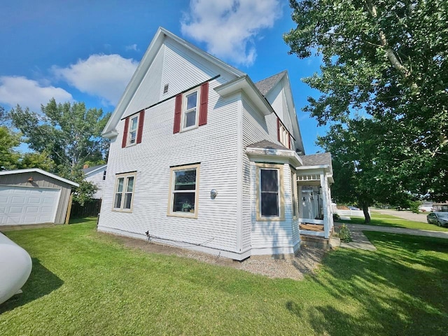 401 5th St, Rugby, ND 58368 - view of property exterior featuring a yard, a shingled roof, an outdoor structure, and a garage