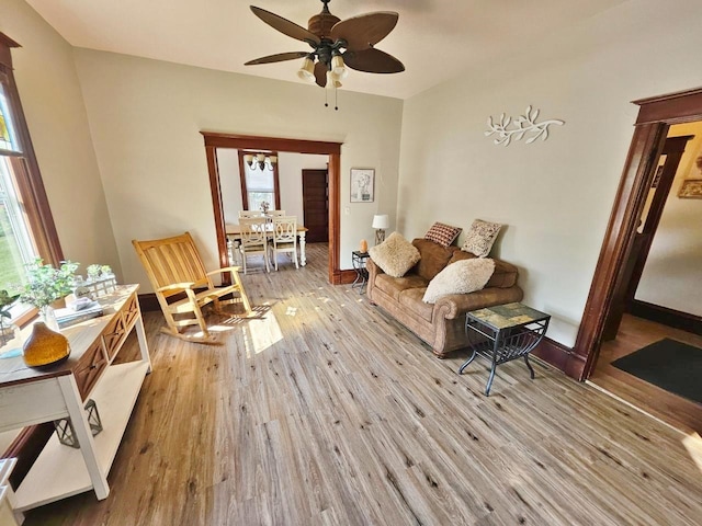 sitting room with ceiling fan and light wood-type flooring