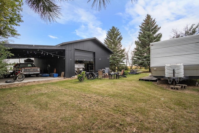 view of yard with a carport and a garage