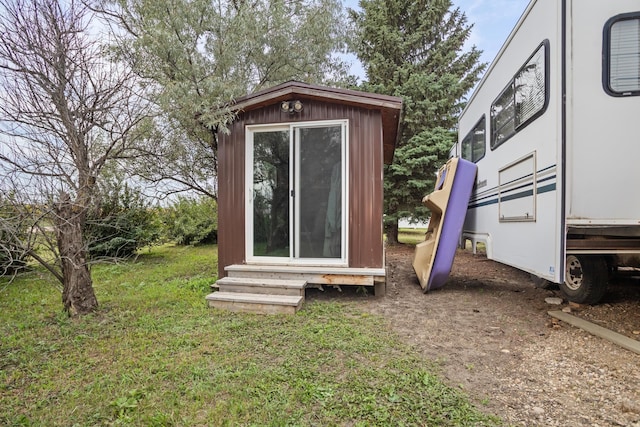 view of outbuilding featuring a lawn