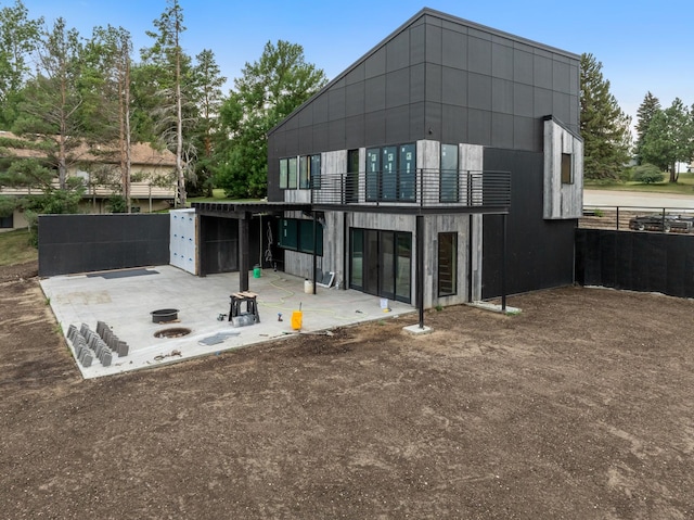 rear view of house featuring a balcony