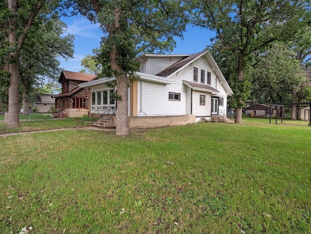 view of home's exterior featuring brick siding and a lawn