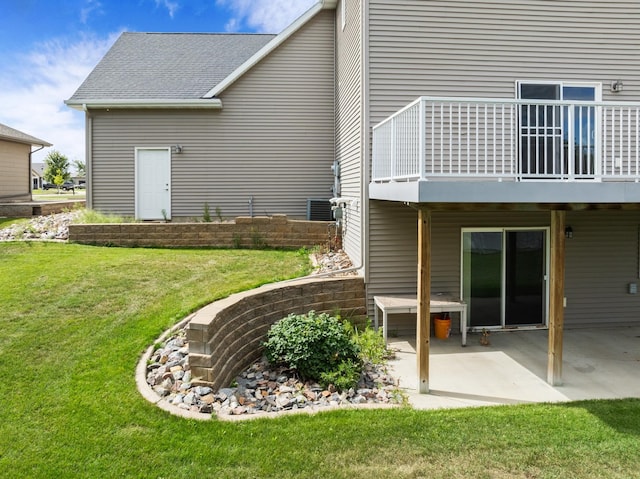 rear view of property with a lawn and a patio area