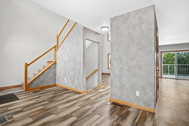 unfurnished living room with wood-type flooring