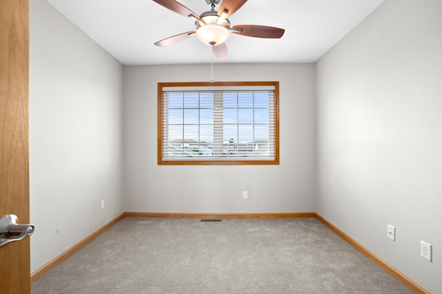 empty room with light colored carpet and ceiling fan