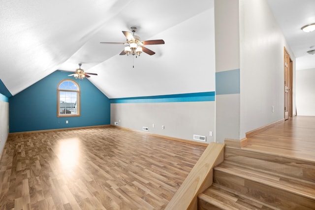 additional living space with lofted ceiling, ceiling fan, and wood-type flooring