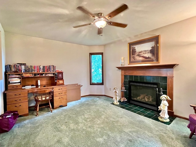 carpeted office space featuring ceiling fan and a tile fireplace