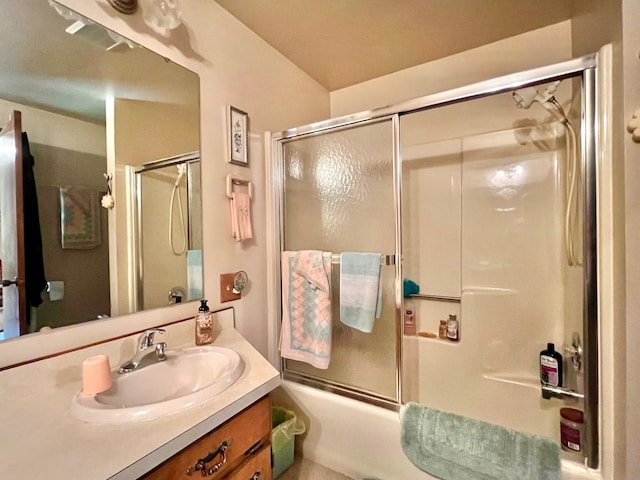 bathroom with shower / bath combination with glass door and vanity