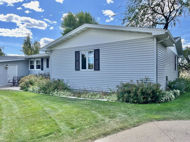 view of property exterior with a lawn