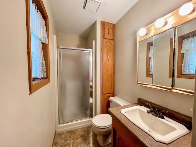 full bathroom featuring tile patterned floors, vanity, toilet, and a shower stall