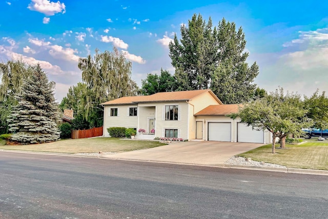 raised ranch with a garage and a front yard