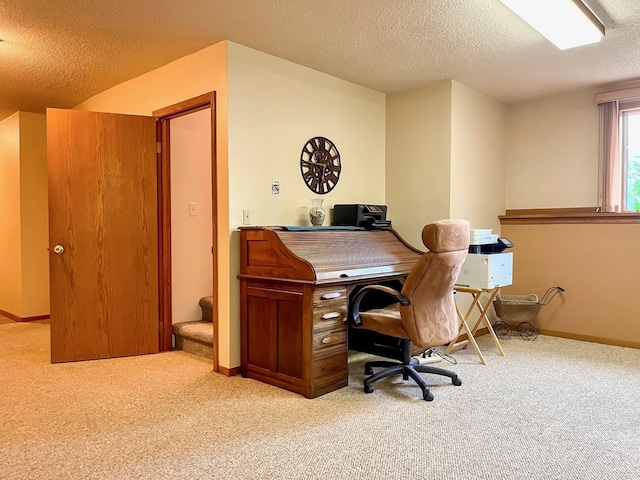 office area featuring carpet flooring, baseboards, and a textured ceiling