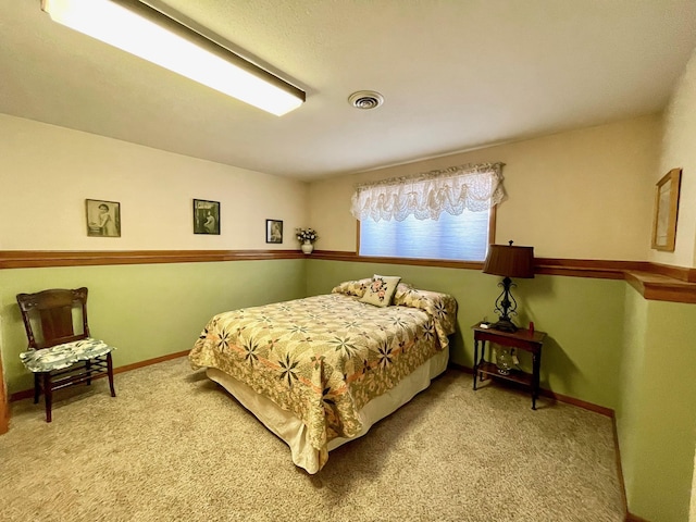 bedroom with carpet, visible vents, and baseboards