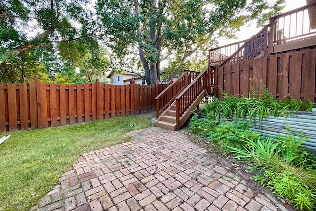 view of patio with stairs and a fenced backyard