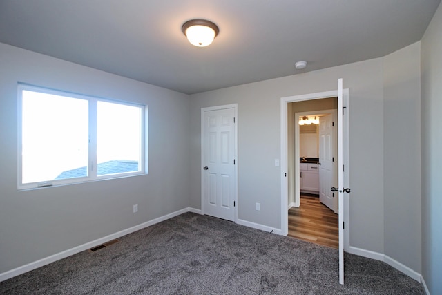 unfurnished bedroom with a closet and carpet