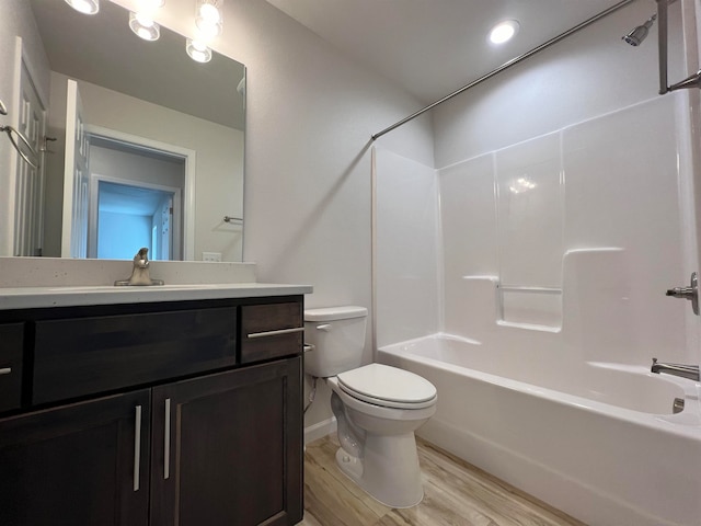 full bathroom with vanity, toilet, wood-type flooring, and bathtub / shower combination