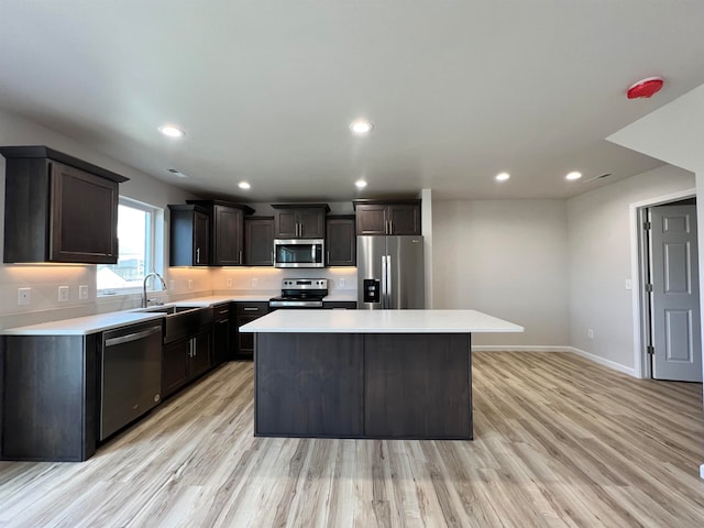 kitchen featuring a center island, stainless steel appliances, and light hardwood / wood-style flooring