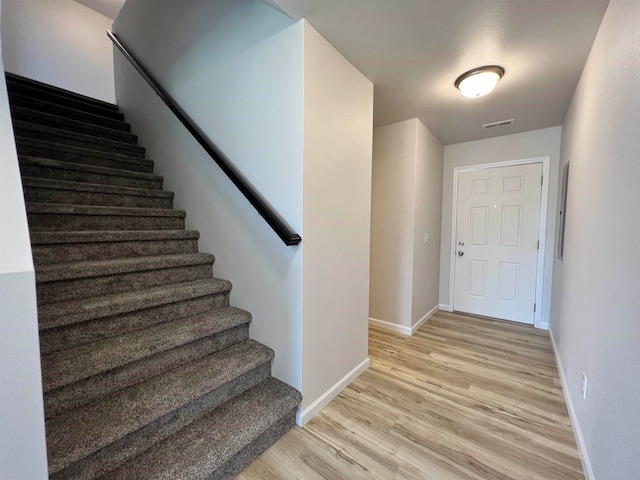 stairs with wood-type flooring