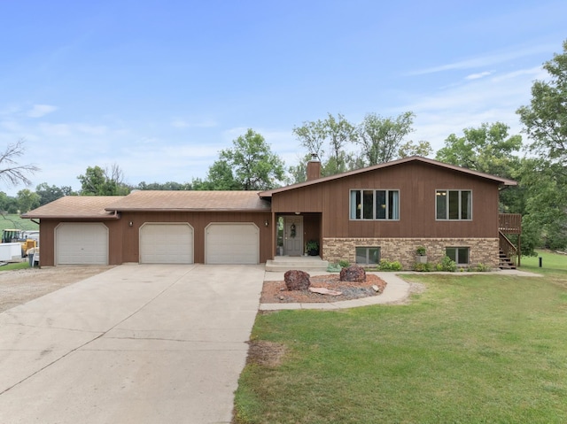 tri-level home with a front lawn and a garage