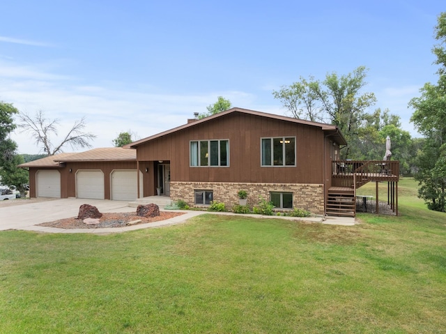 view of front of house featuring a wooden deck, a front yard, and a garage