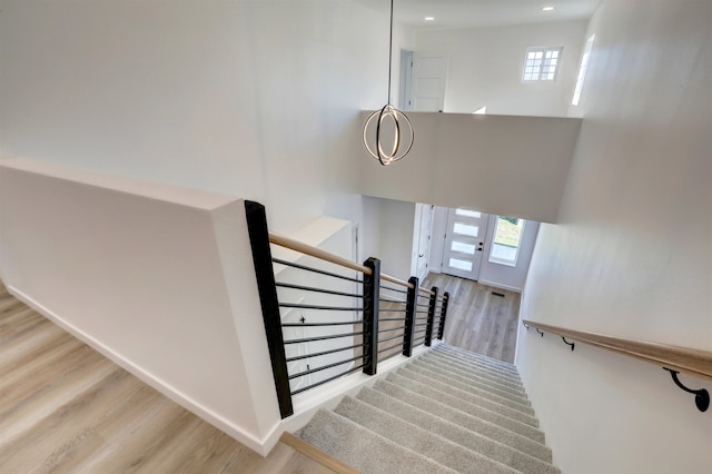 stairway with hardwood / wood-style floors