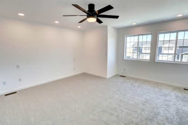 carpeted empty room featuring ceiling fan