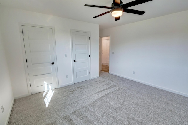 unfurnished bedroom featuring light carpet and ceiling fan