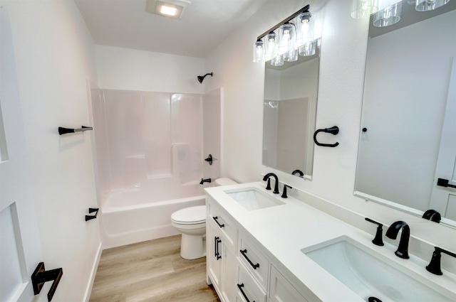 full bathroom with vanity, toilet, shower / bath combination, and hardwood / wood-style floors