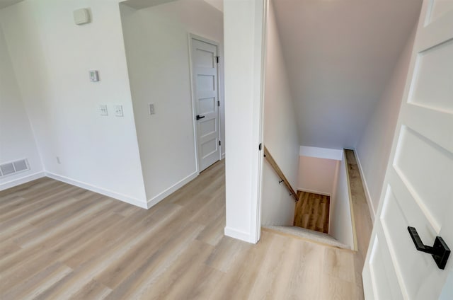 hallway with light hardwood / wood-style floors