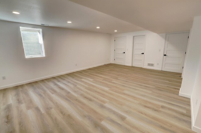 unfurnished room with hardwood / wood-style flooring