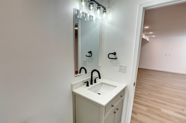 bathroom with hardwood / wood-style flooring and vanity