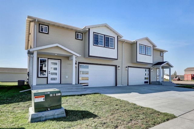 view of front facade with a front yard, central AC unit, and a garage