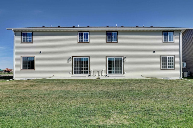 back of house featuring central air condition unit, a yard, and a patio