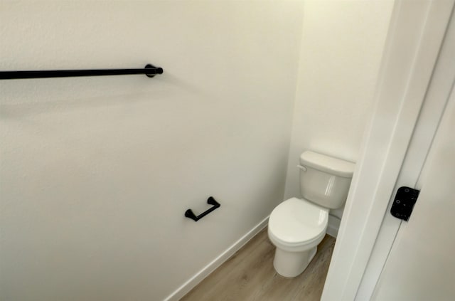 bathroom featuring toilet and hardwood / wood-style flooring