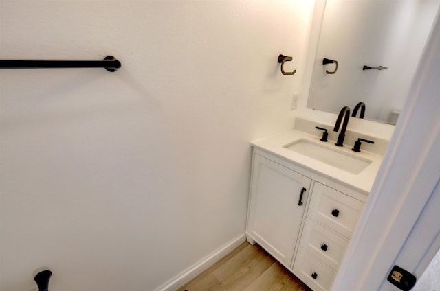 bathroom featuring hardwood / wood-style floors and vanity